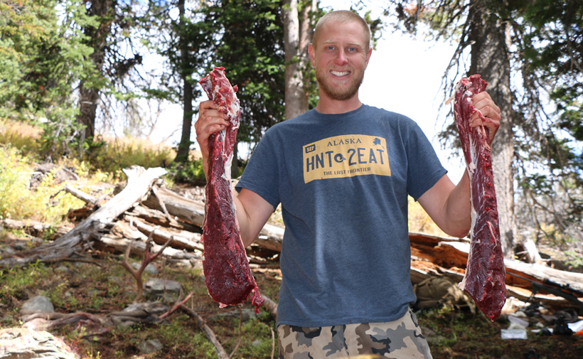 Darrick with mule deer meat Darrick with mule deer meat